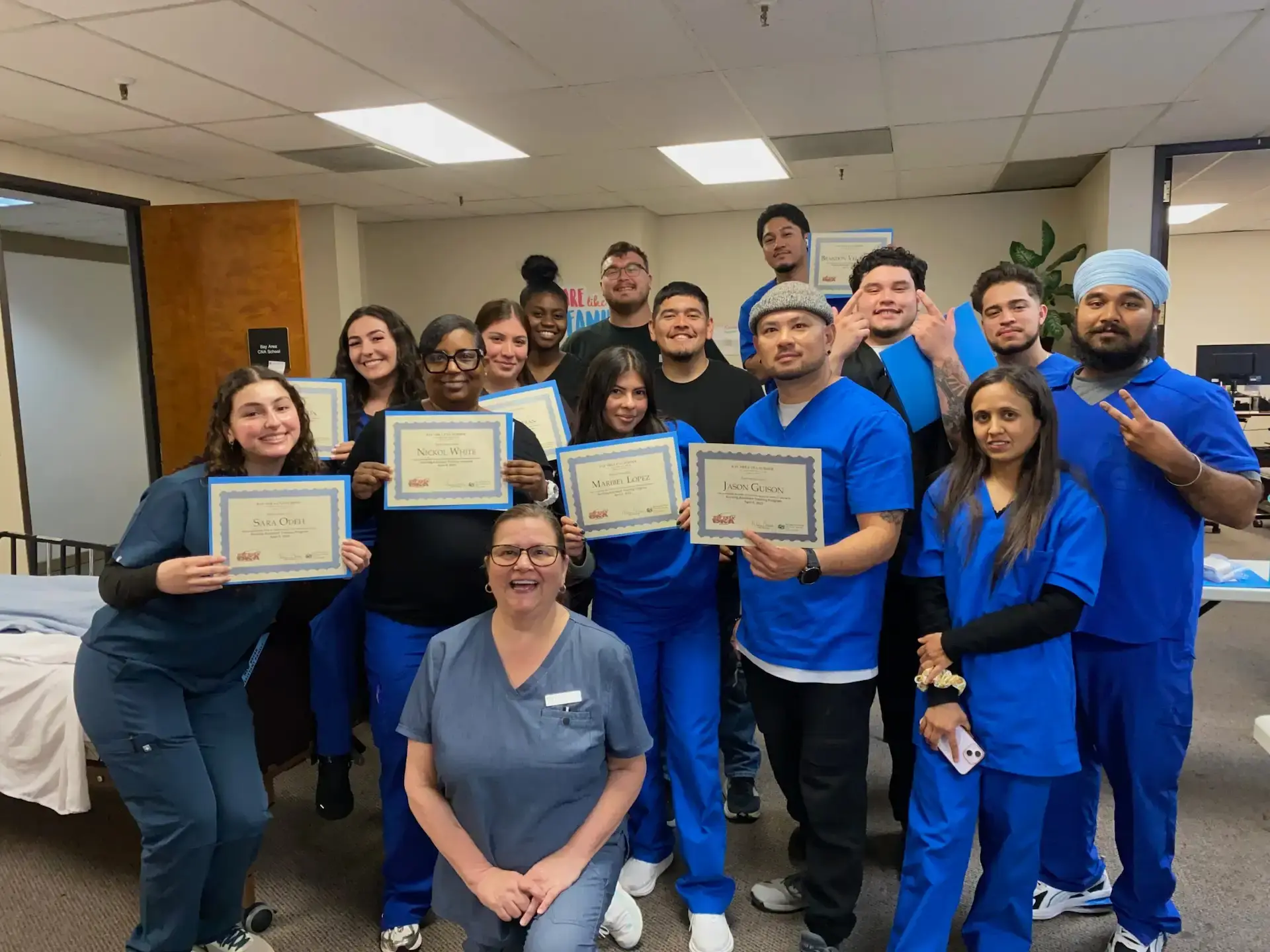 Bay Area CNA School graduates posing with their instructor